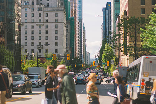 People crossing a busy city street