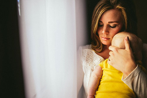 Mother holding a baby closely